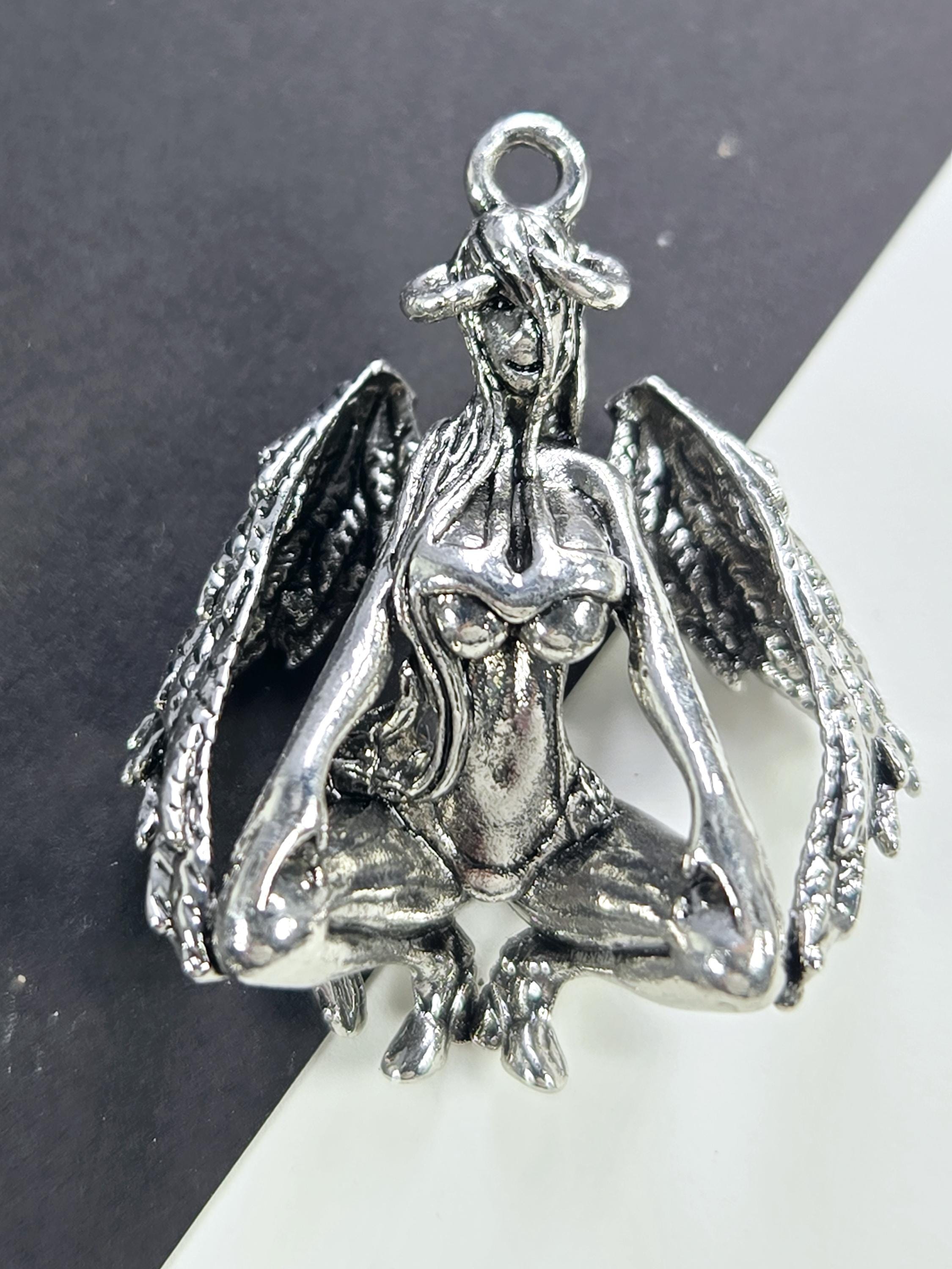 A silver-colored metal charm in the shape of a bird, with intricate details and a textured appearance.