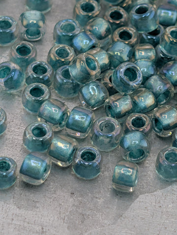 a collection of small, clear glass beads scattered on a surface.