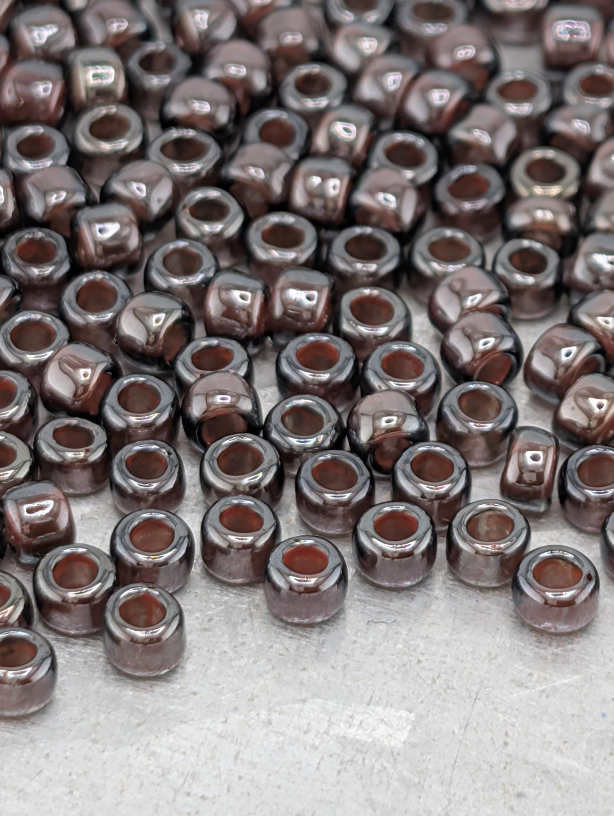 a large number of brown glass beads scattered across a surface.