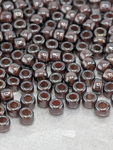 a large number of brown glass beads scattered across a surface.