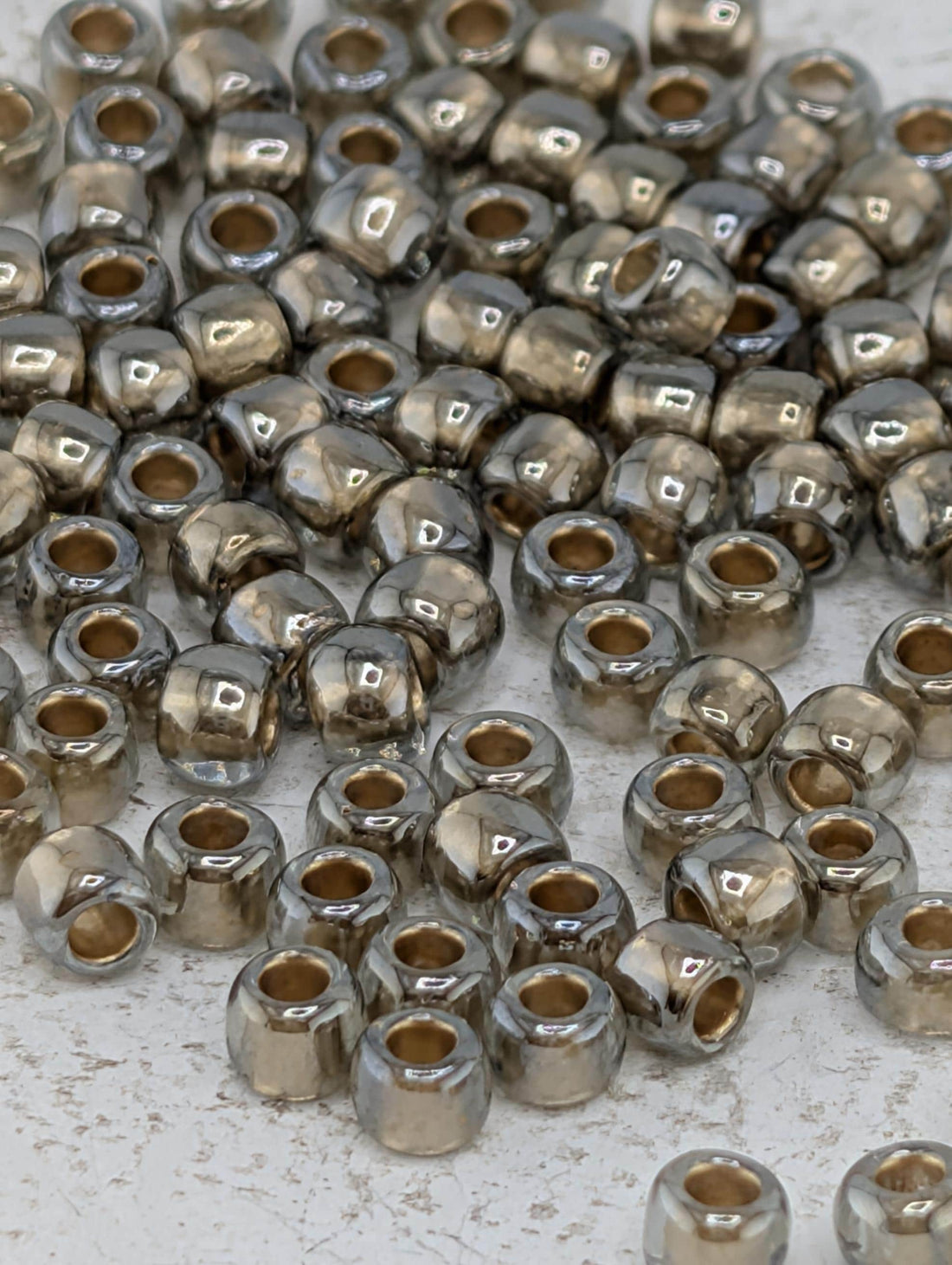 a collection of small, shiny metal beads scattered across a surface.