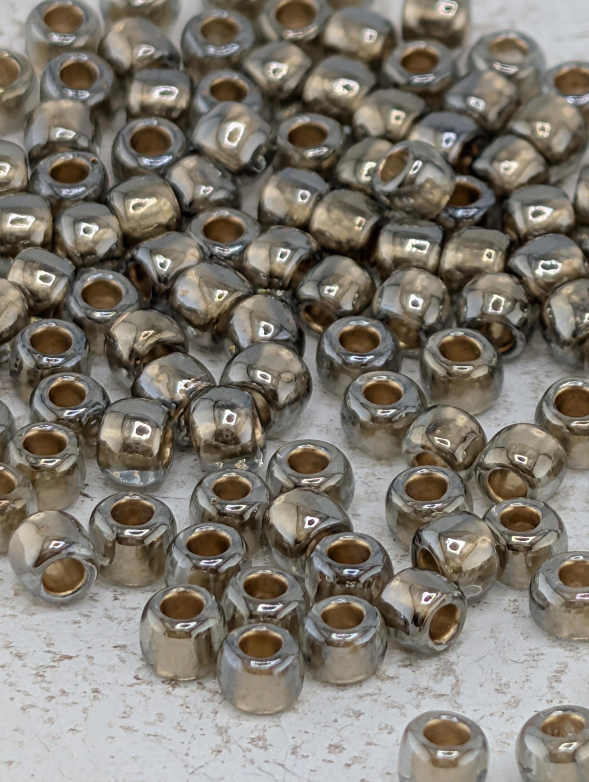 a collection of small, shiny metal beads scattered across a surface.
