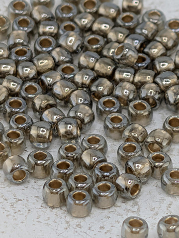 a collection of small, shiny metal beads scattered across a surface.