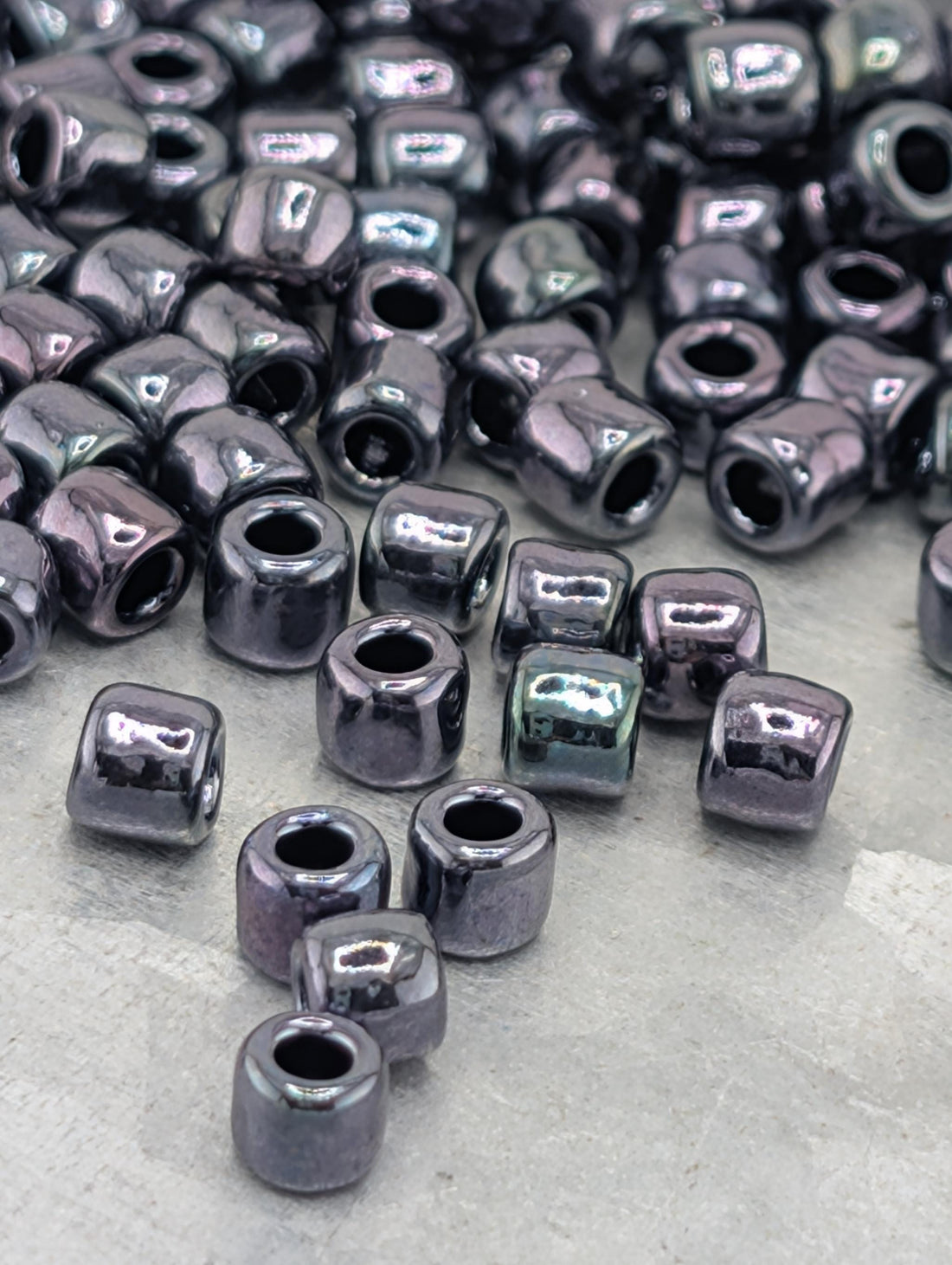 a collection of small, shiny, and metallic beads scattered on a surface.