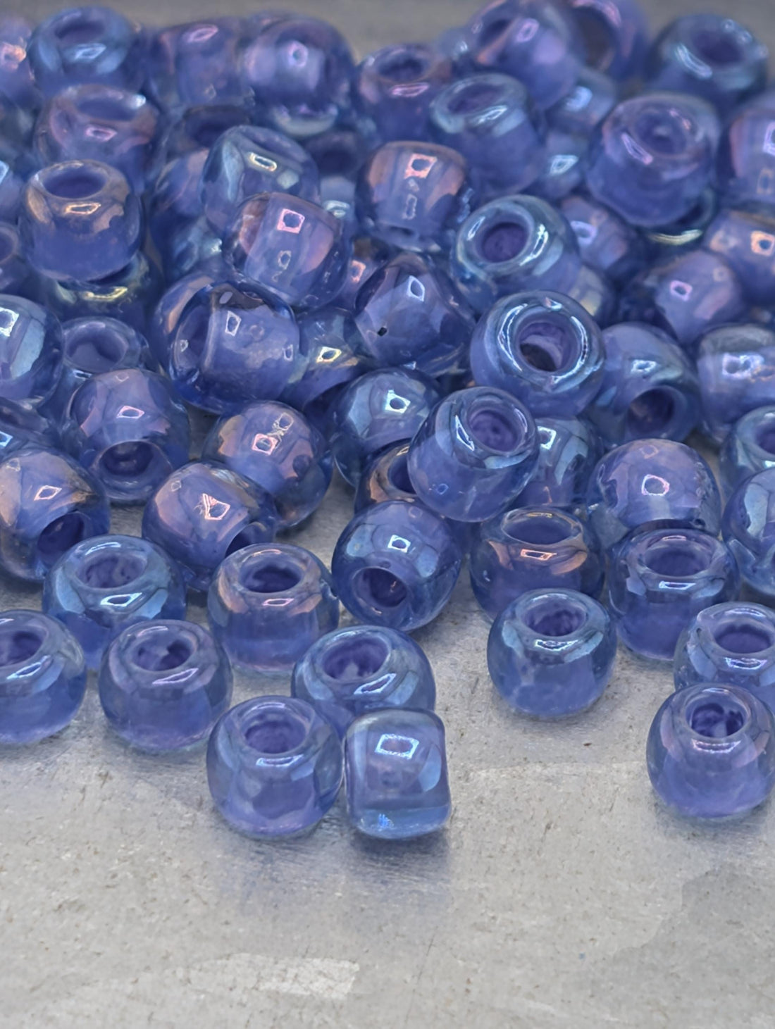 a collection of small, clear beads in various shades of blue, scattered across a surface.