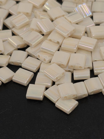 a collection of small, white, square-shaped objects scattered on a dark background.