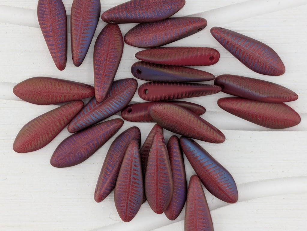 a collection of red and blue beads arranged on a white surface.