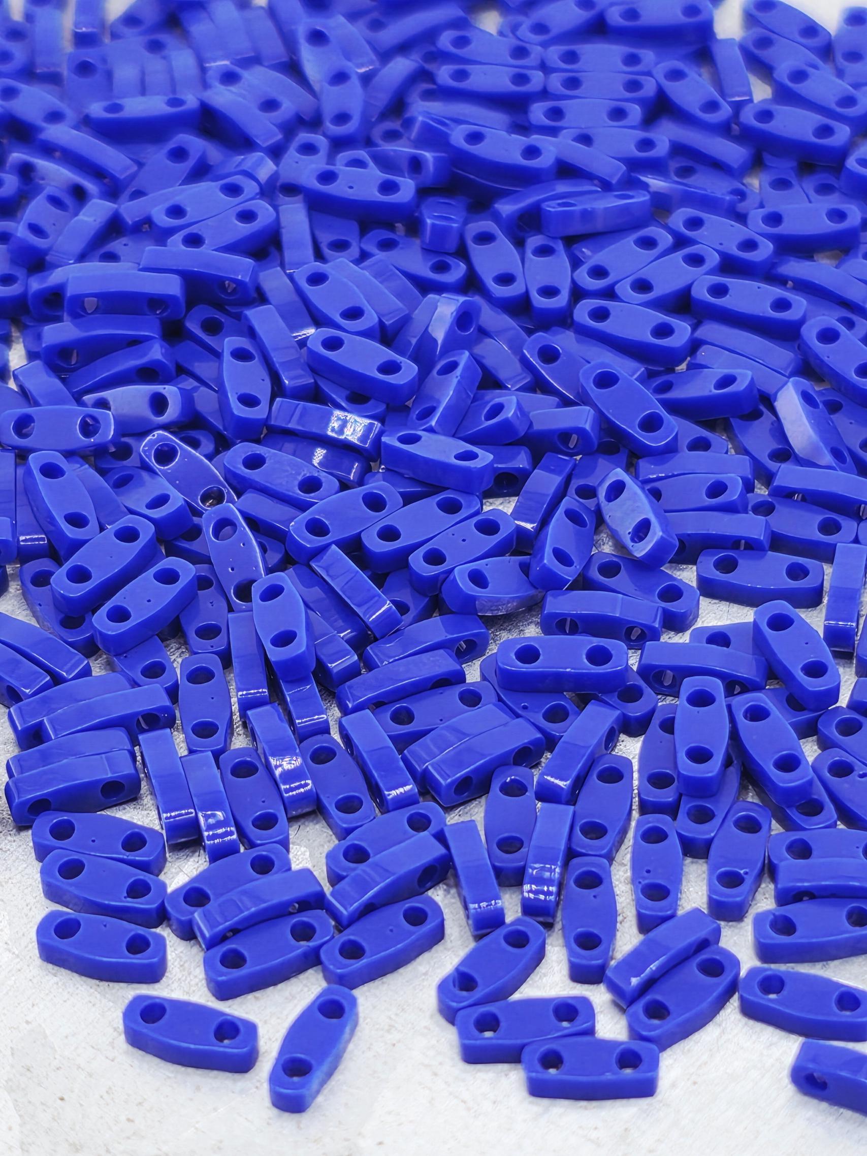 numerous blue plastic pieces scattered across a surface.