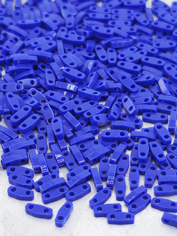 numerous blue plastic pieces scattered across a surface.