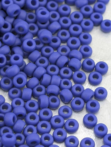 a collection of small, round, blue beads scattered across a surface.