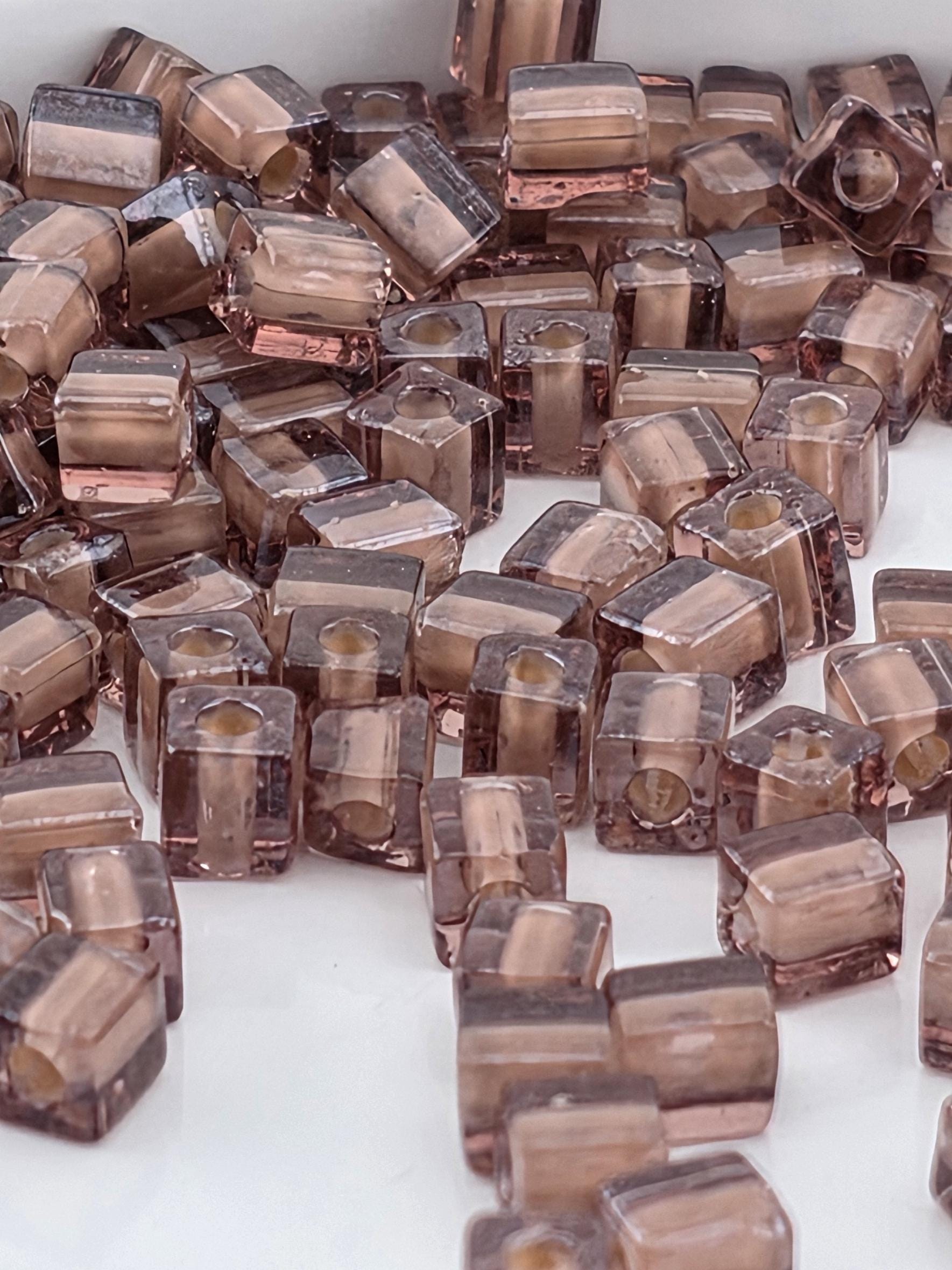 numerous small, square-shaped objects that appear to be made of a translucent material, possibly glass or a similar material. The objects are scattered across a surface, creating a visually interesting and somewhat chaotic arrangement.