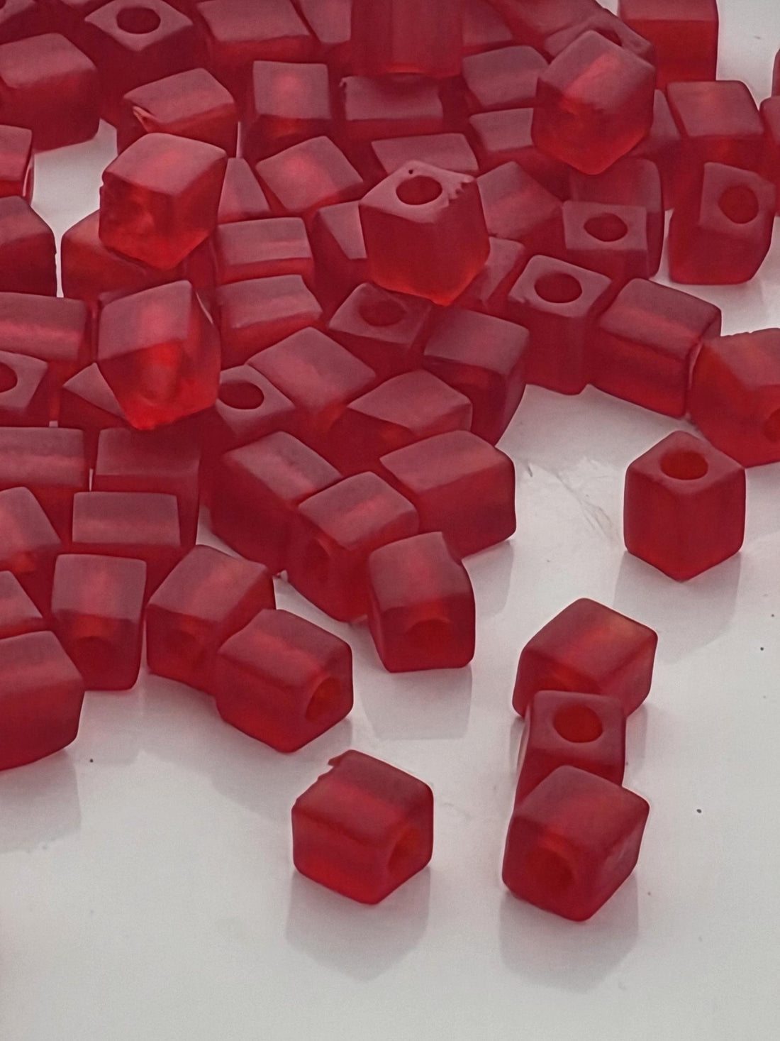 numerous red, square-shaped objects scattered across a surface, creating a visually striking and vibrant scene.