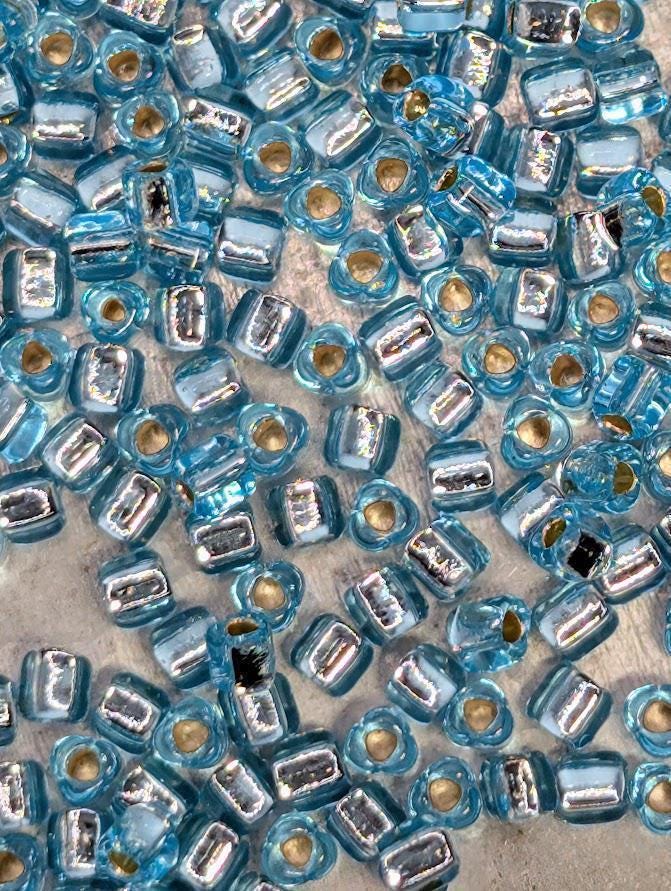 Blue Topaz Translucent Silver Lined Miyuki Triangle Size 8/0 (15g Pkg)