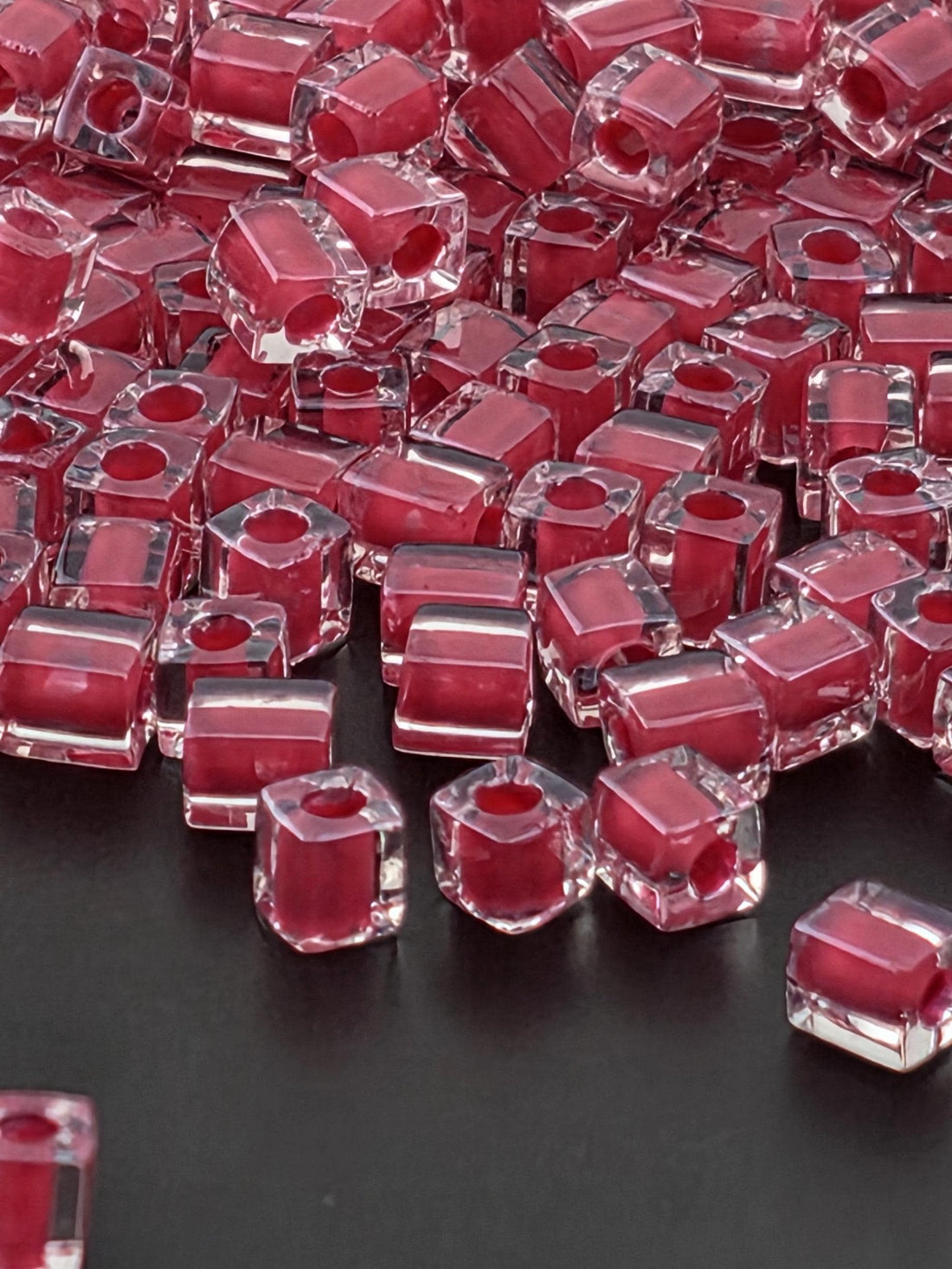 numerous clear, transparent, and red-colored cubes or blocks arranged in a visually striking manner.