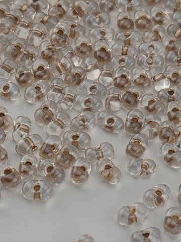 a collection of clear glass beads scattered across a white surface.