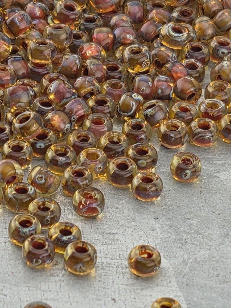 a large pile of small, clear glass beads scattered on a surface.