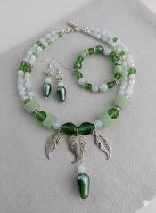 A collection of various colorful beads, gemstones, and metal charms arranged on a surface.