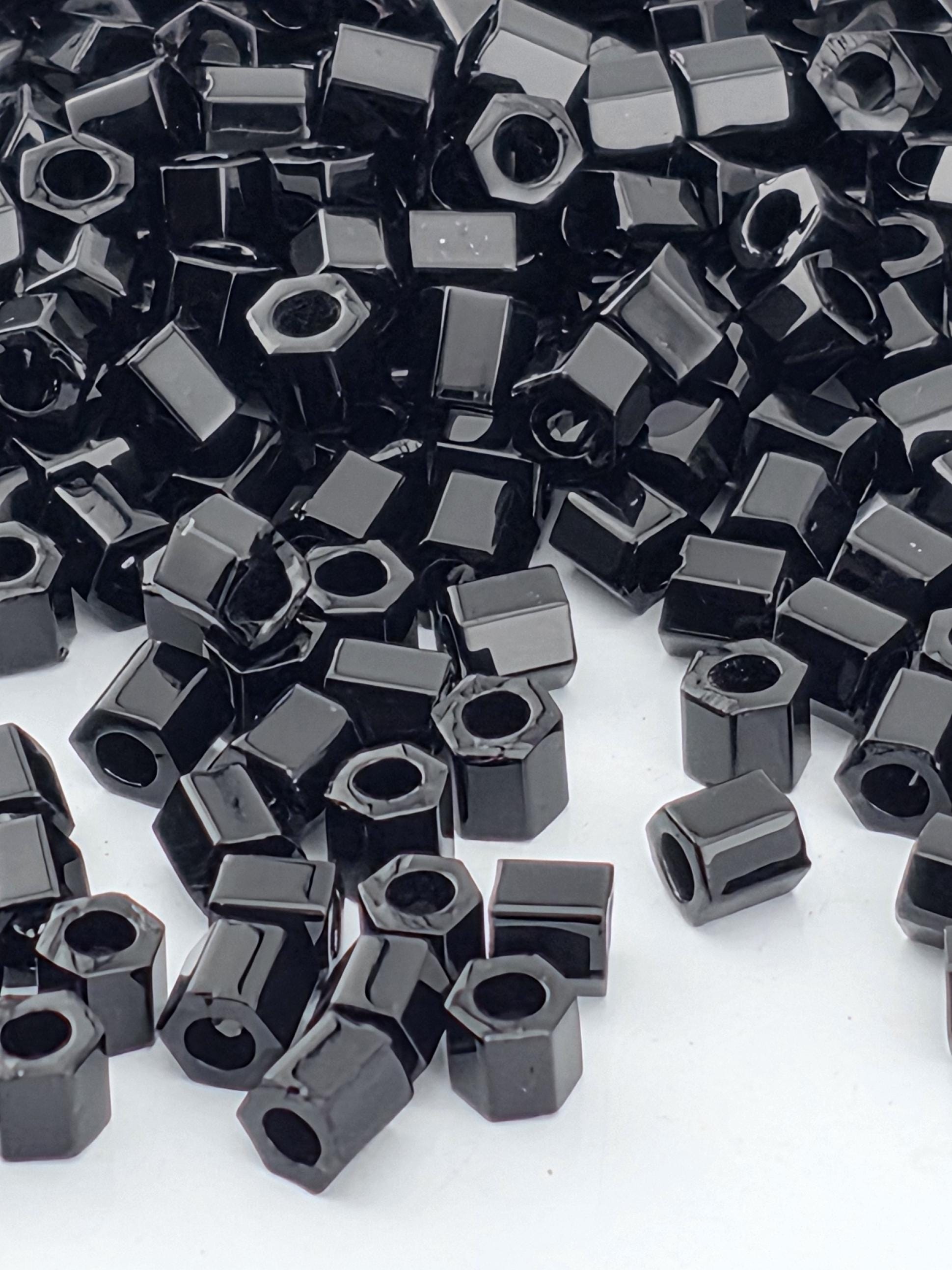 numerous black hexagonal objects scattered across a white background.