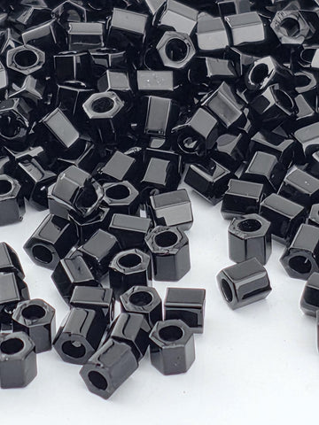 numerous black hexagonal objects scattered across a white background.