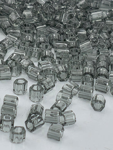 numerous small, clear glass beads scattered across a surface.