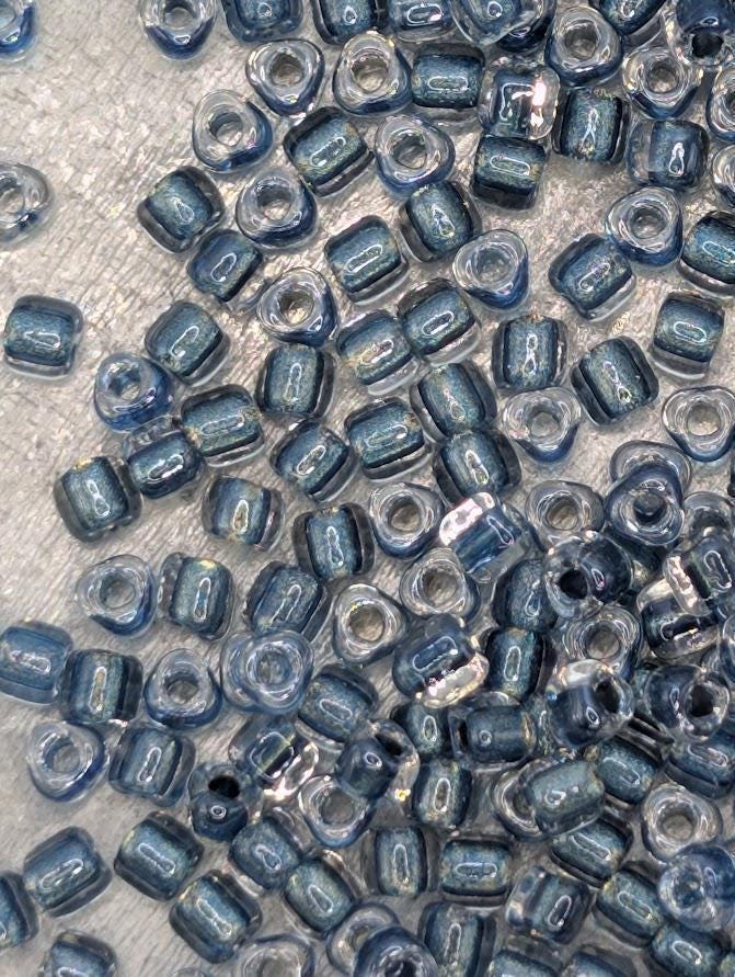 Crystal/Dk Turq Blue Inside Color Lined Sparkle Miyuki Triangle Size 8/0 (15g Pkg)