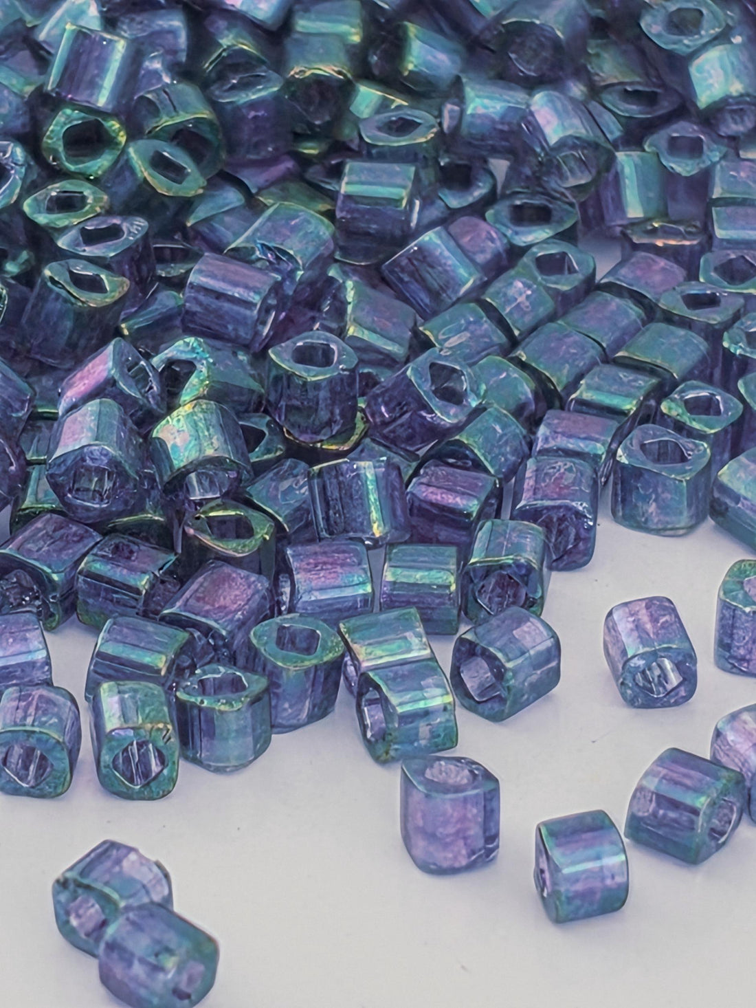a collection of small, colorful beads scattered across a surface.
