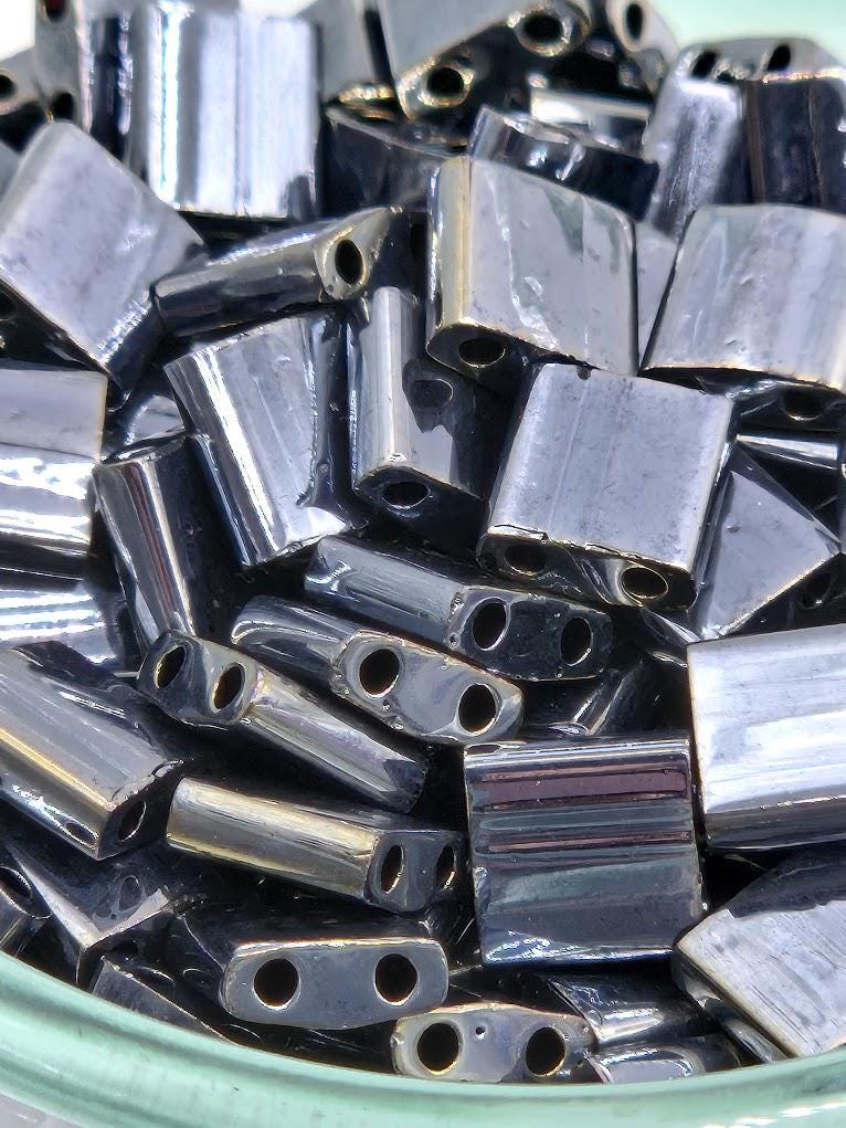 A close-up image of a pile of metal beads or metal pieces, with a variety of shapes and sizes.
