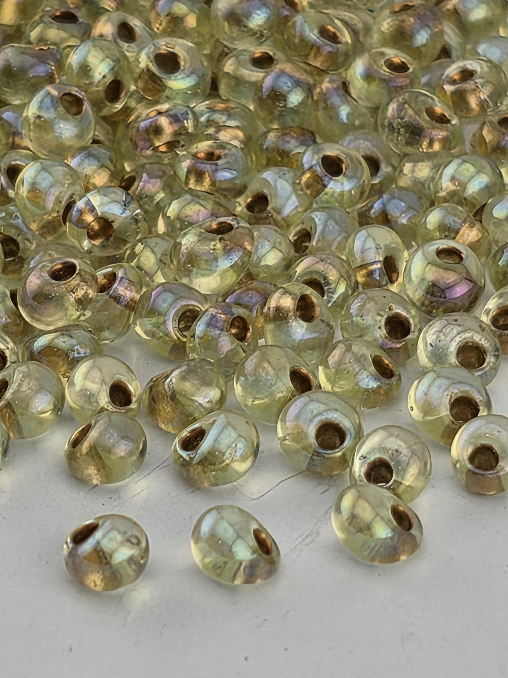a close-up view of numerous small, clear beads scattered across a surface.
