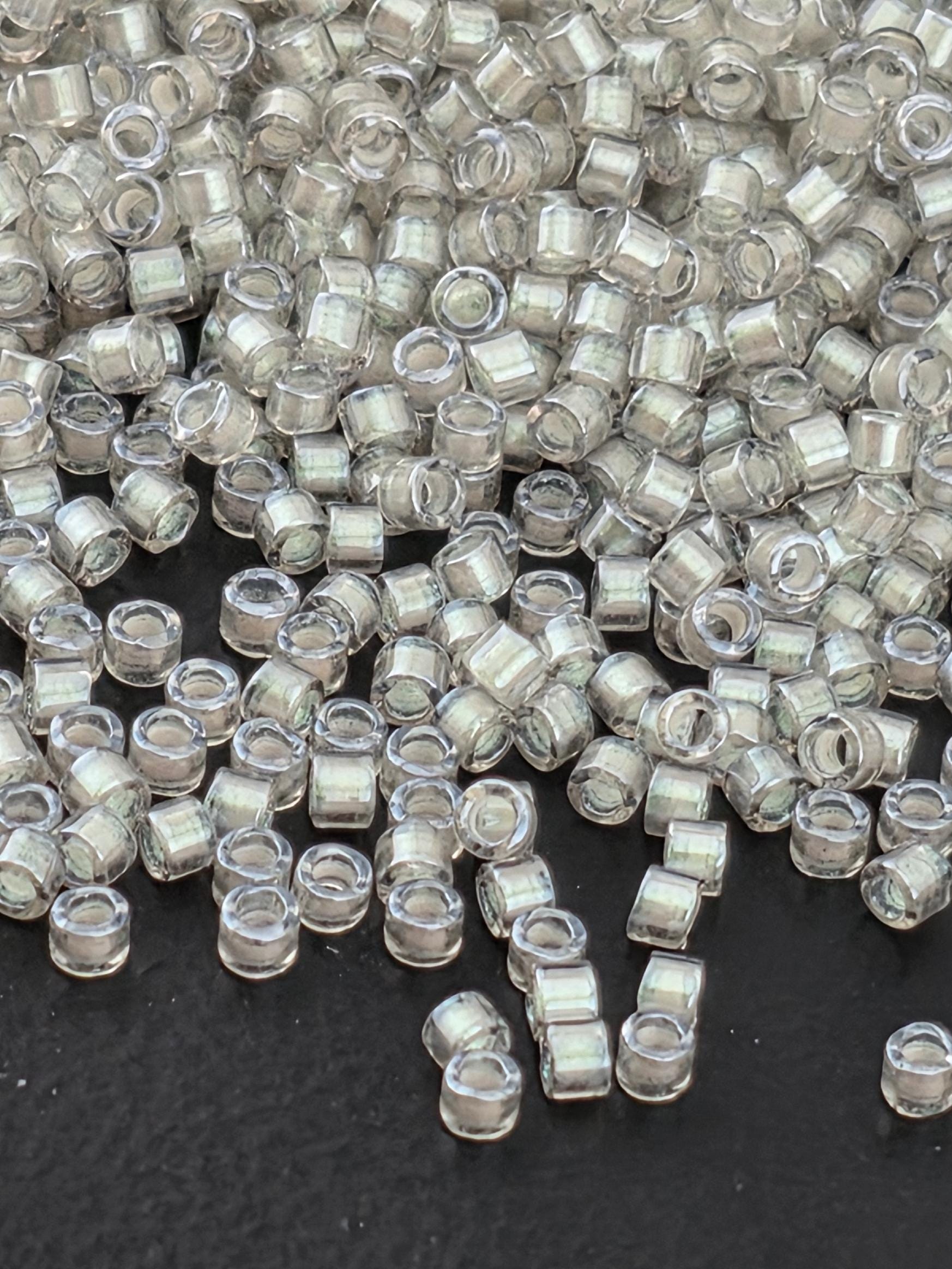 a close-up view of numerous clear, transparent beads scattered on a dark background.
