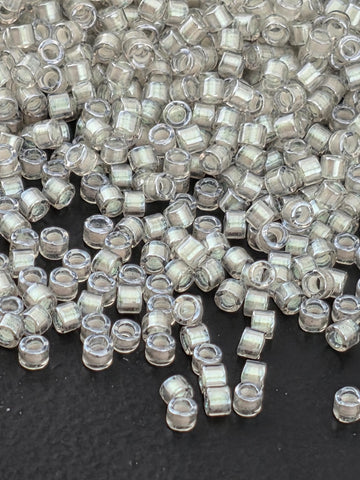 a close-up view of numerous clear, transparent beads scattered on a dark background.