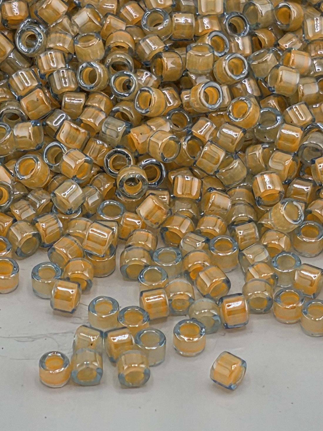 DB2042:Luminous Creamy Praline/Blue Inside Color Lined Miyuki Delica (Size 11, 7 grams, ~1400 beads)