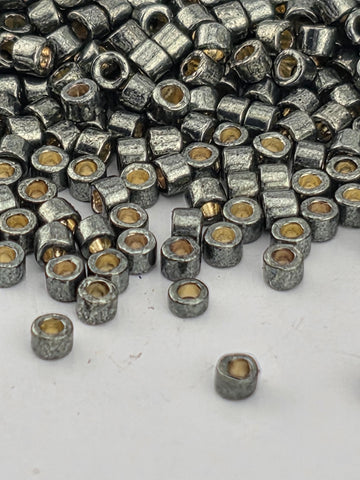 a close-up view of numerous small, round metal beads scattered on a white surface.