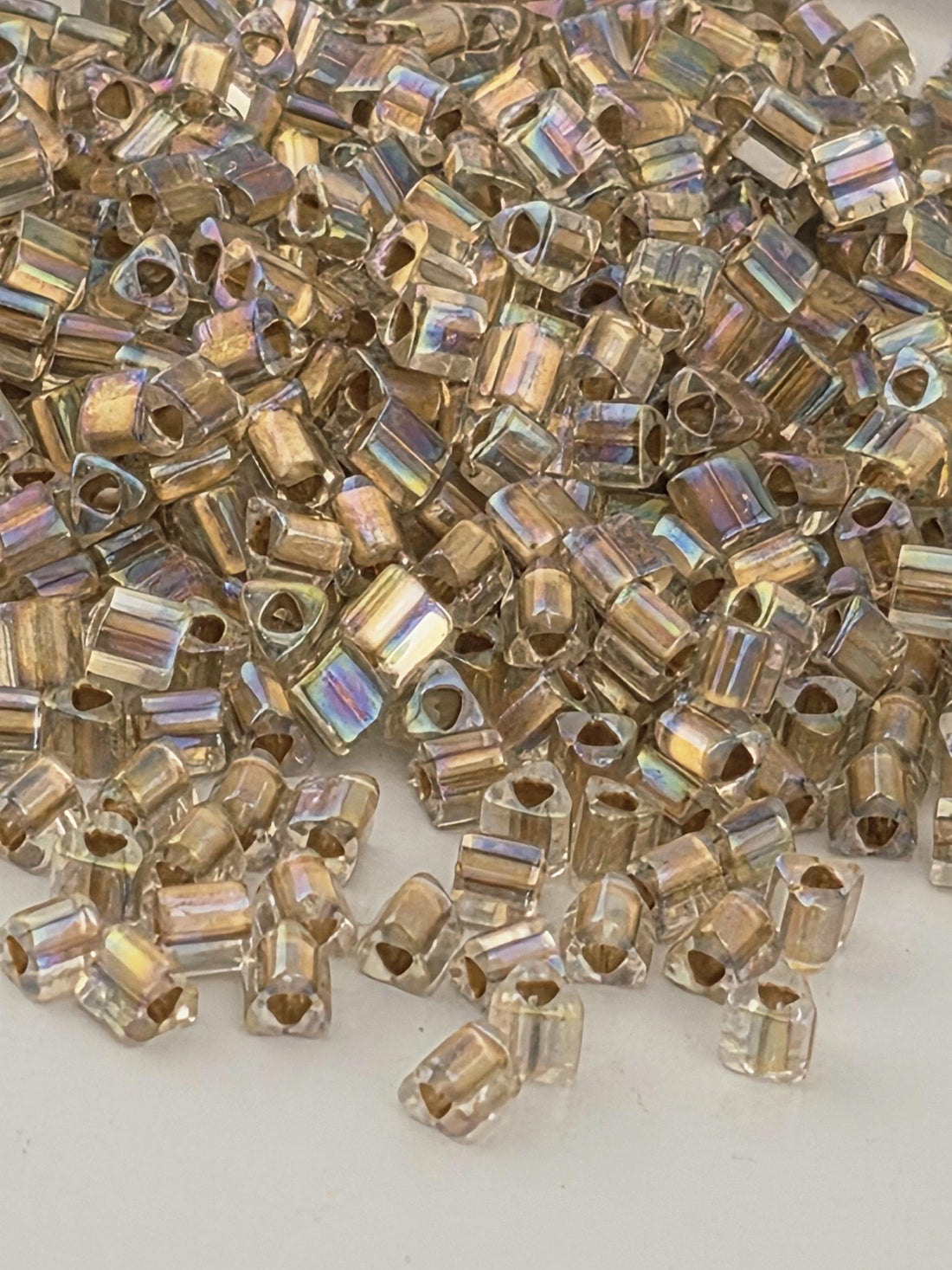 a close-up view of numerous small, clear beads scattered across a surface.