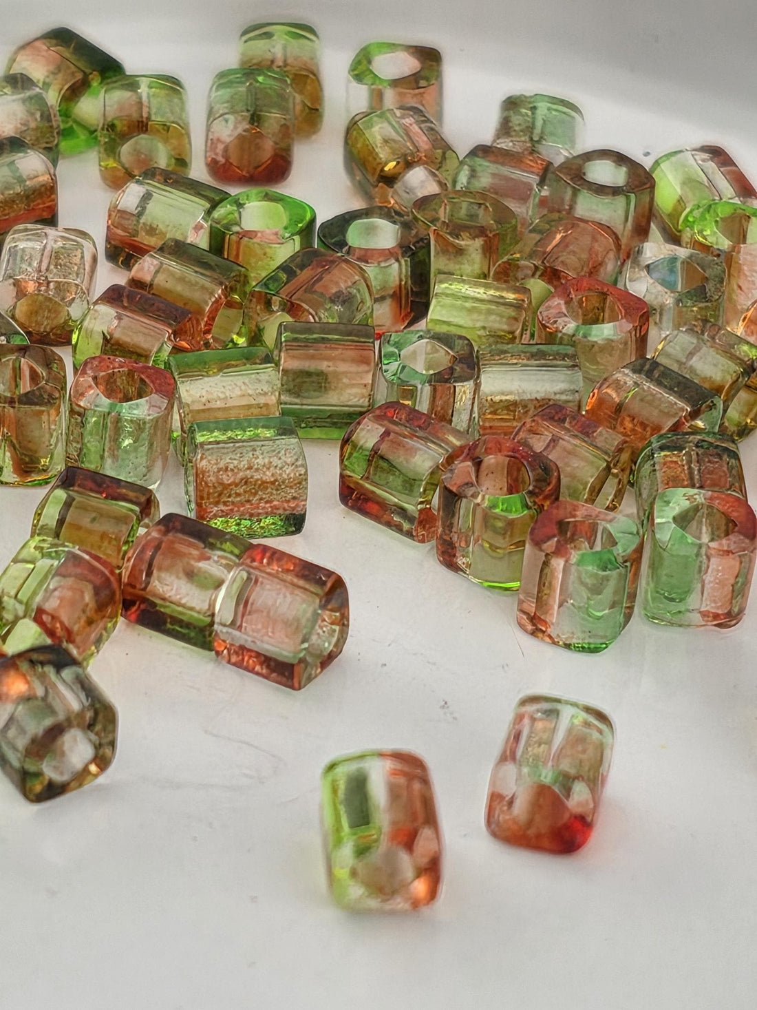 a collection of colorful glass beads scattered on a dark surface.