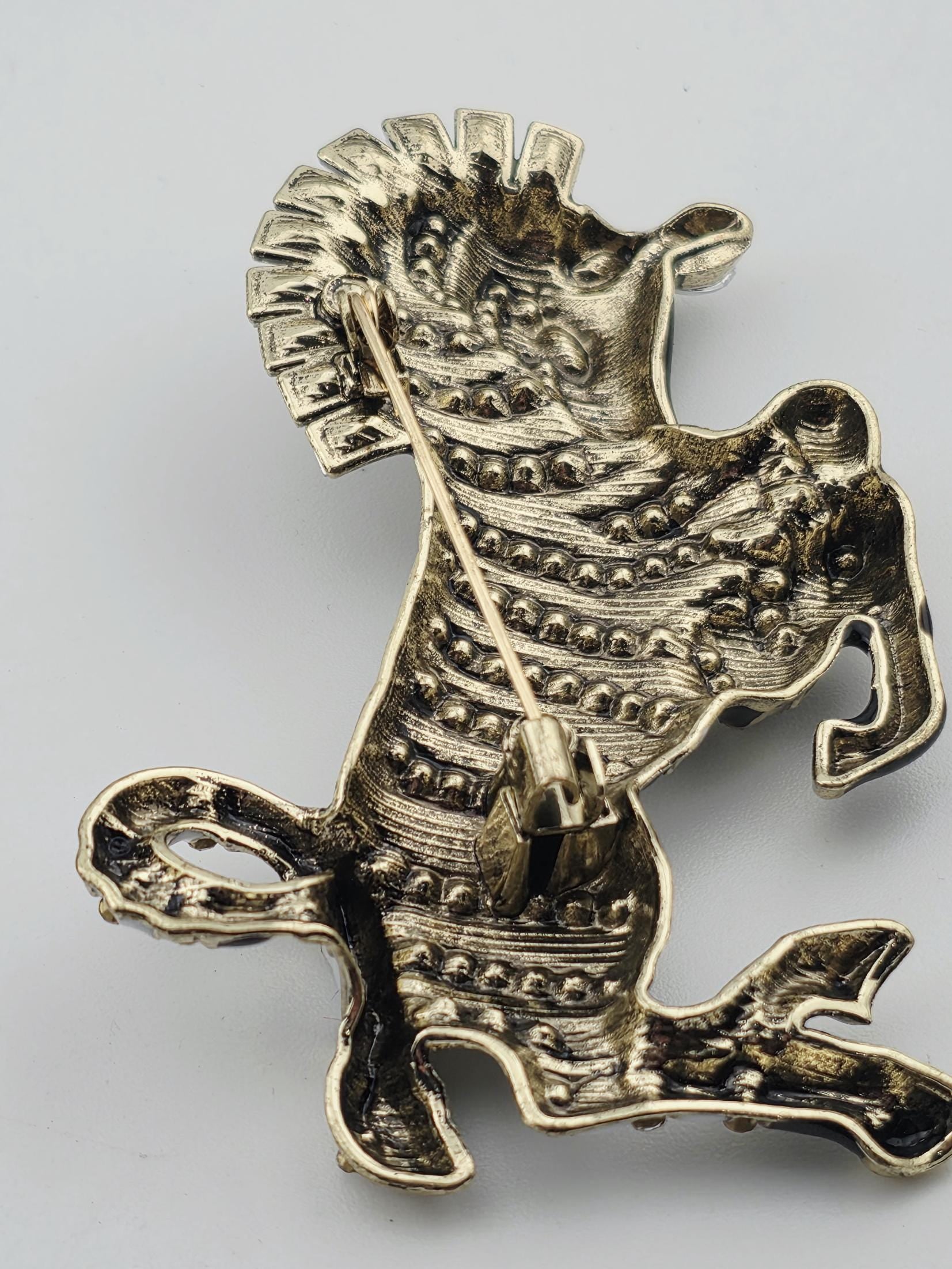 a detailed, intricate metal piece resembling a dragon or mythical creature.
