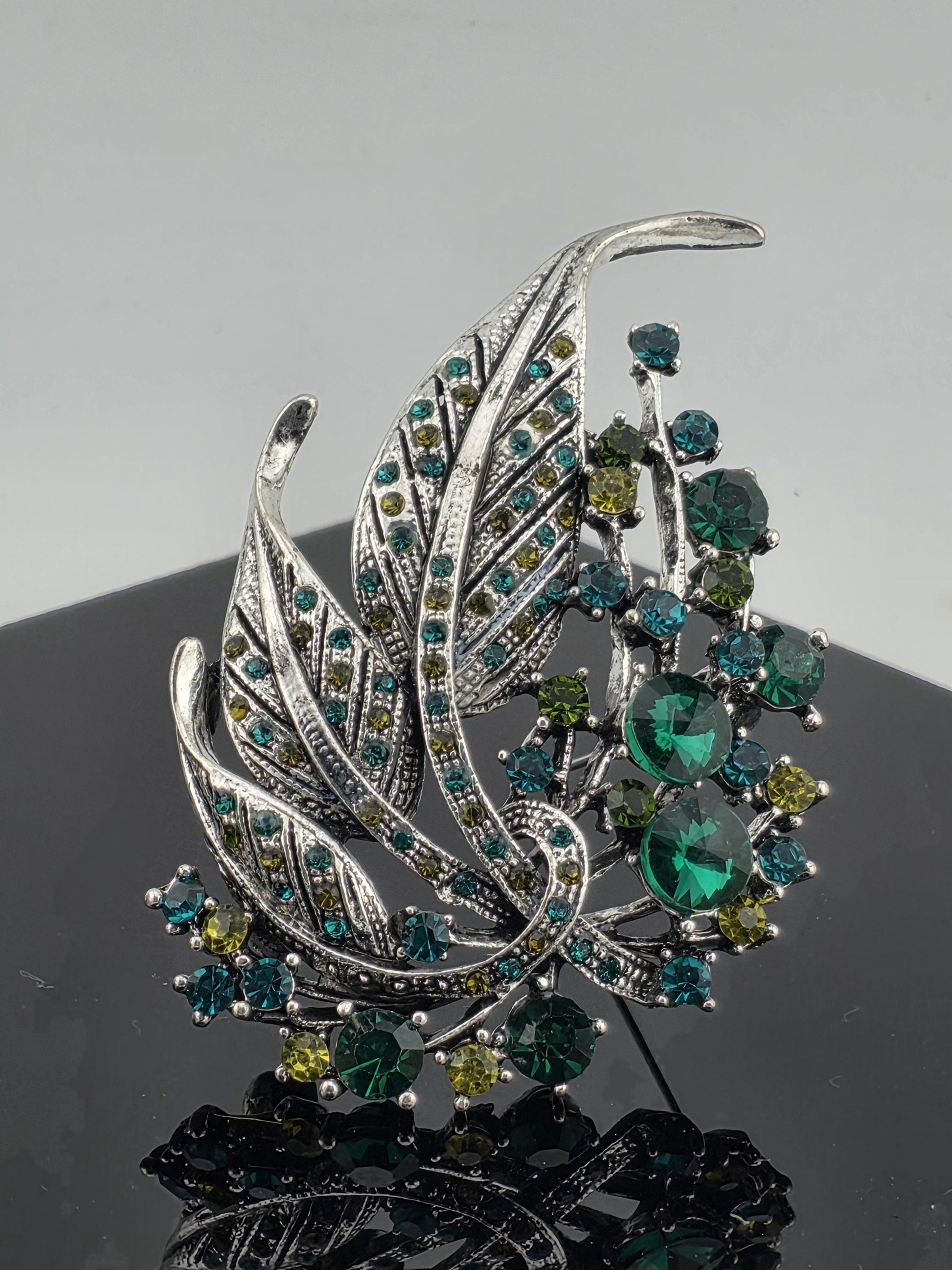Silver Plated Feather Brooch: Blue Topaz and Emerald Rhinestone Pin