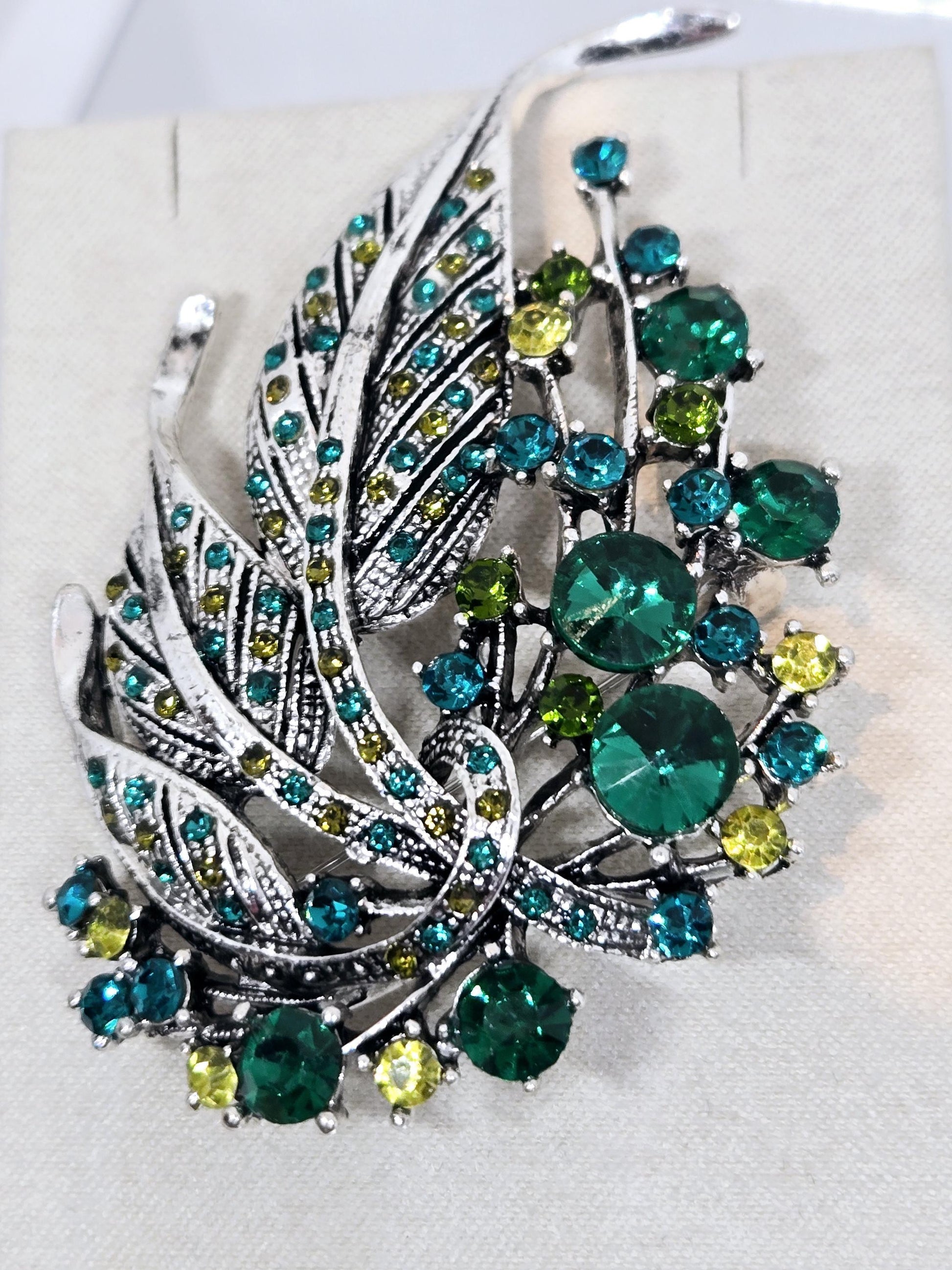 Silver Plated Feather Brooch: Blue Topaz and Emerald Rhinestone Pin