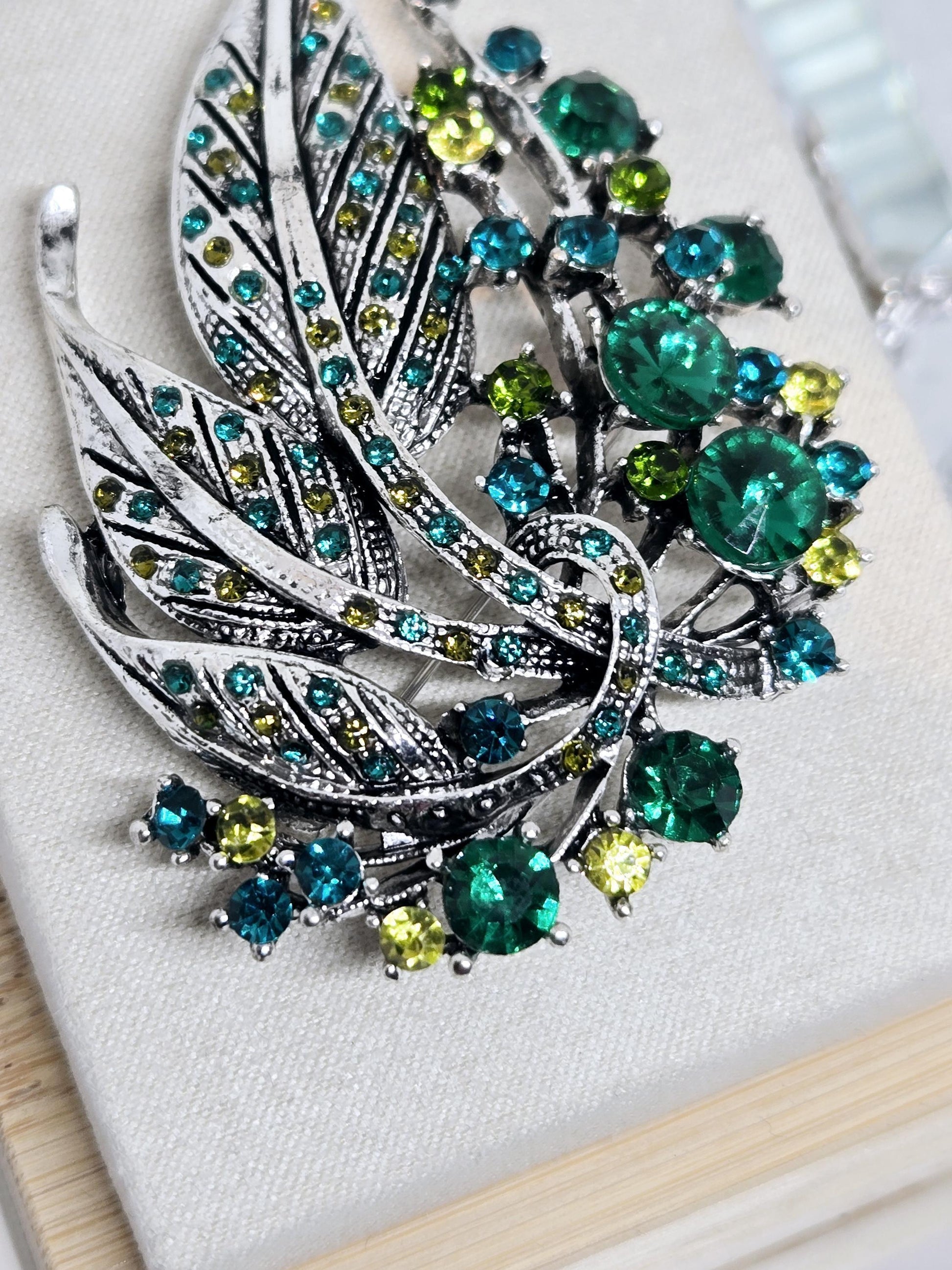 Silver Plated Feather Brooch: Blue Topaz and Emerald Rhinestone Pin