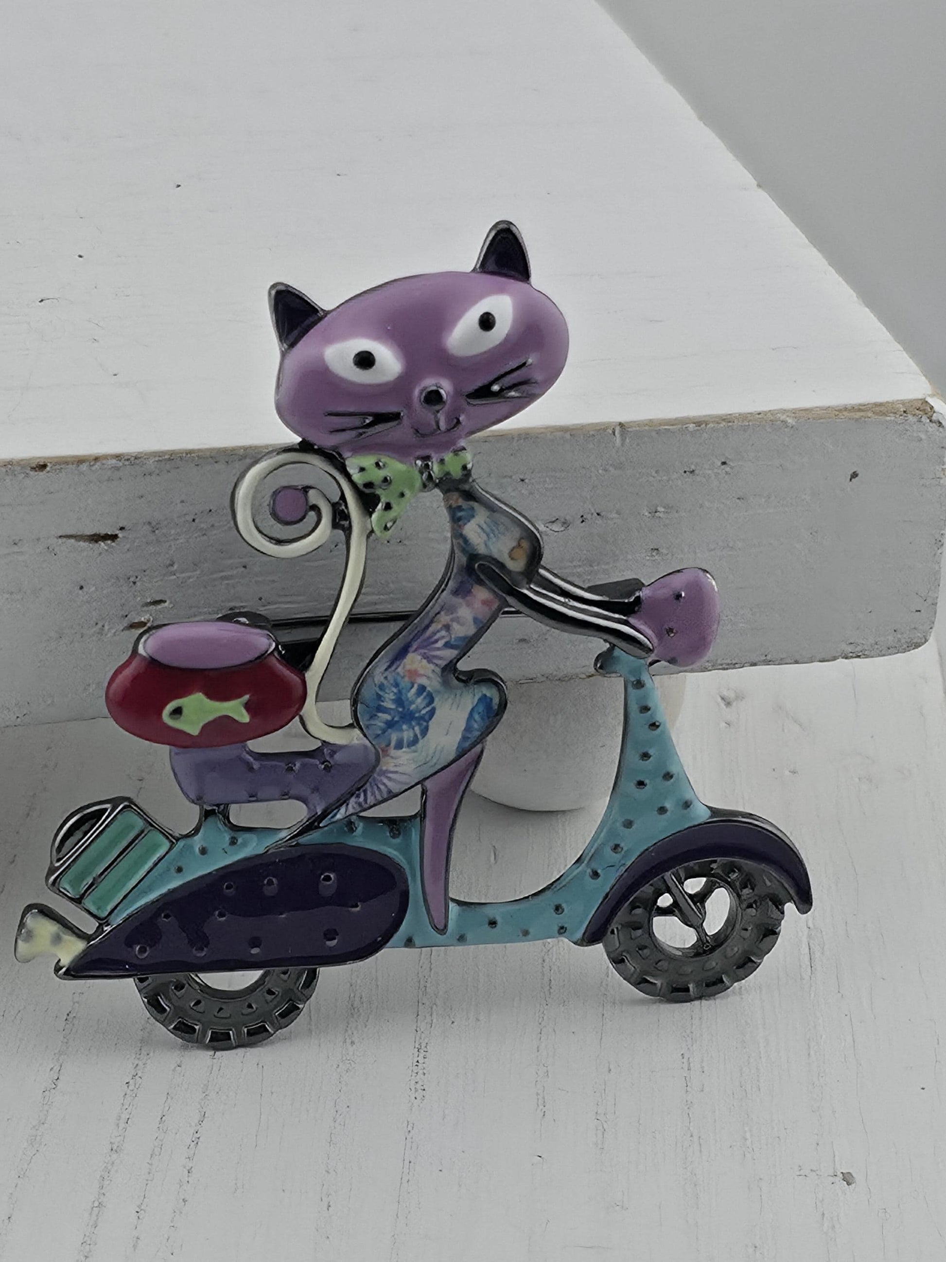 A colorful, whimsical cat-shaped object resembling a toy or decoration, with various shapes and colors.
