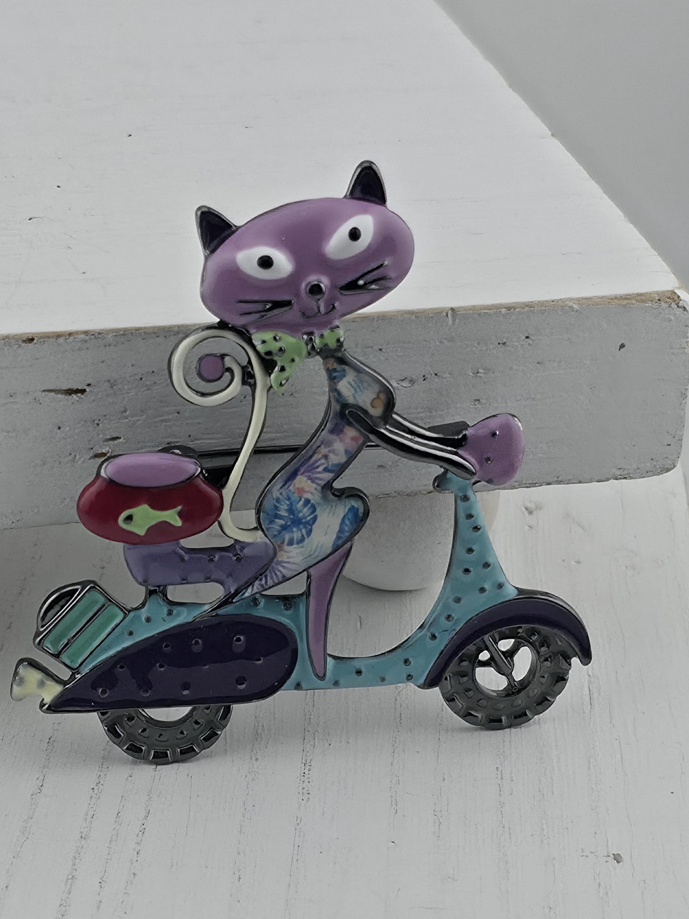 A colorful, whimsical cat-shaped object resembling a toy or decoration, with various shapes and colors.
