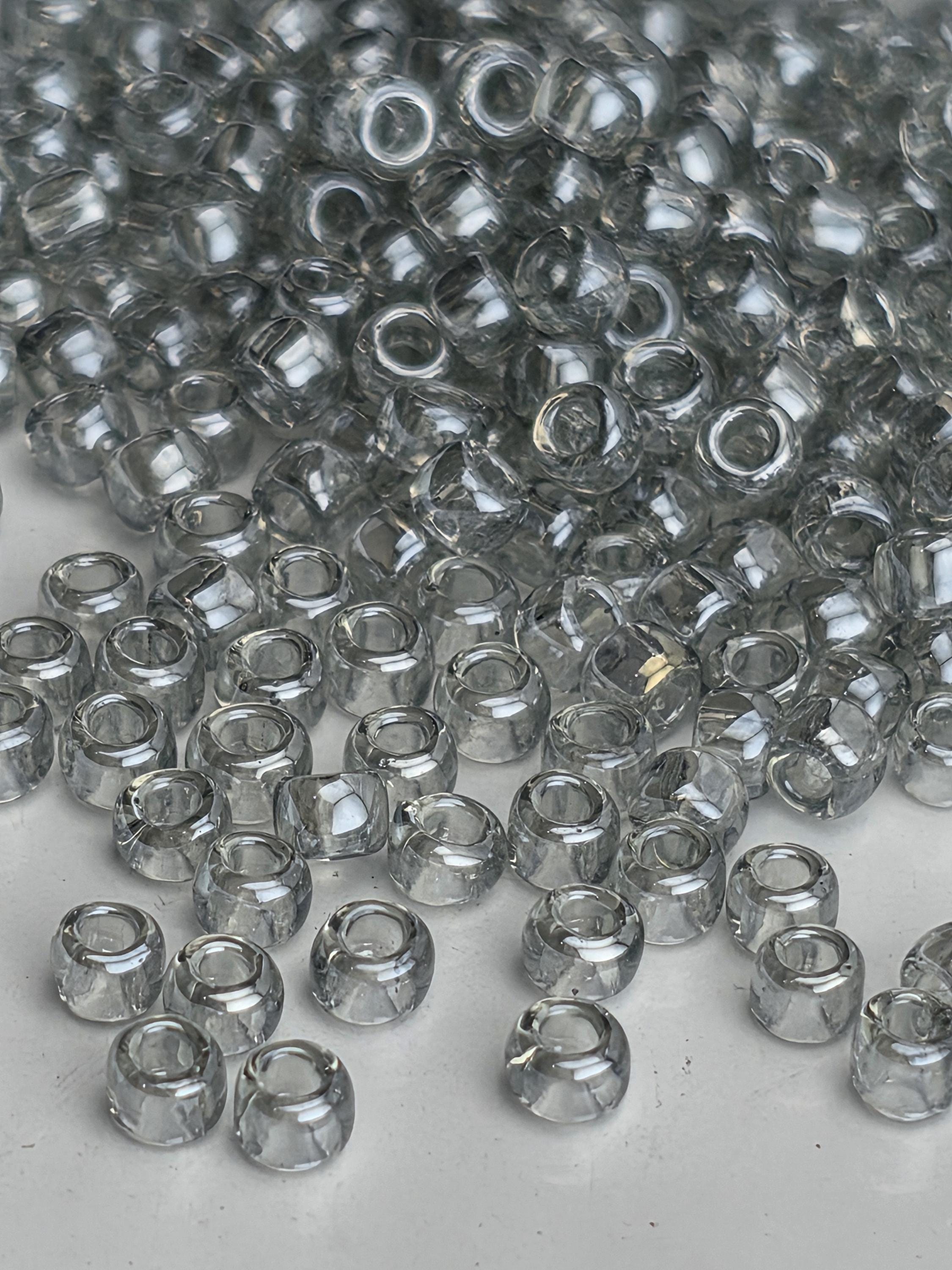 a close-up view of numerous clear glass beads scattered on a surface.
