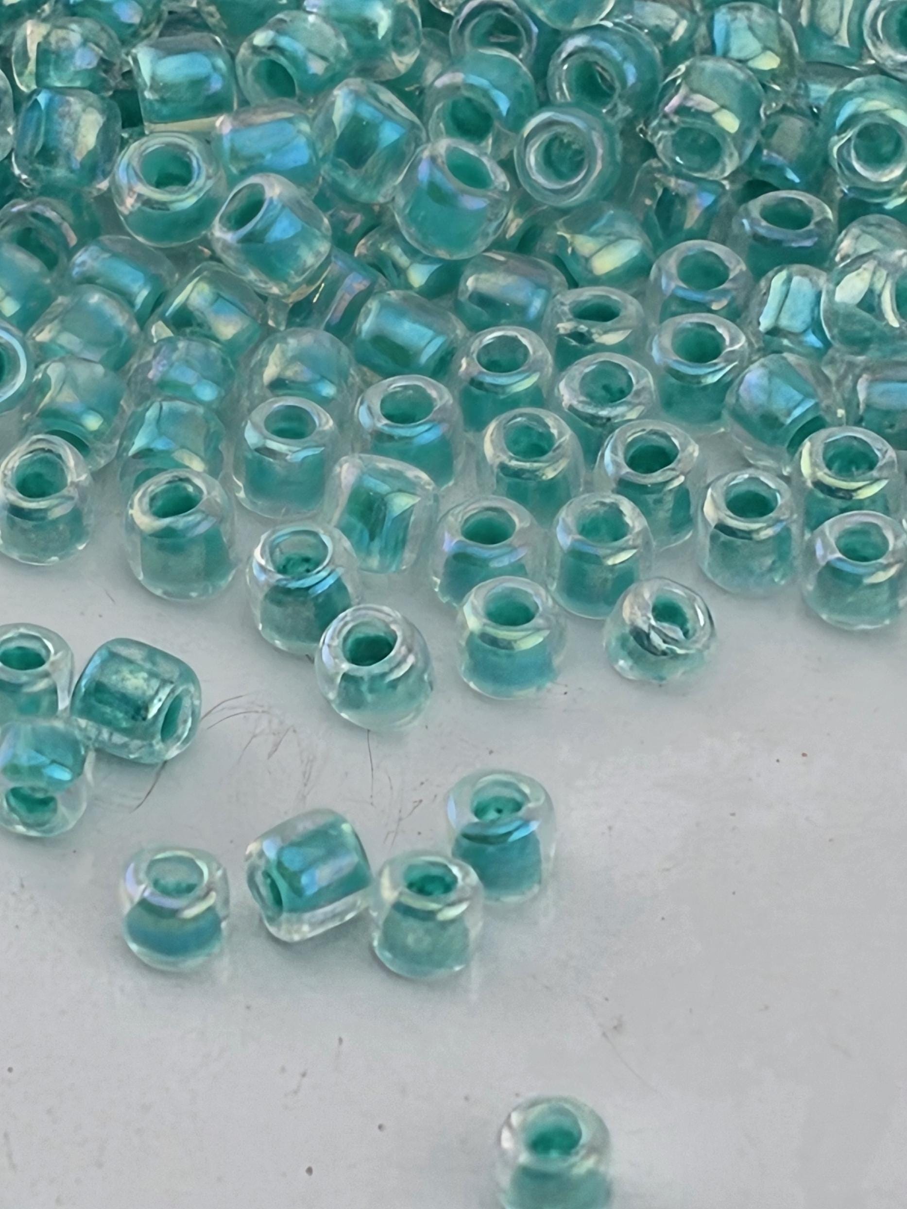 a collection of small, clear beads scattered on a white surface.