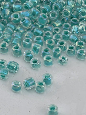 a collection of small, clear beads scattered on a white surface.