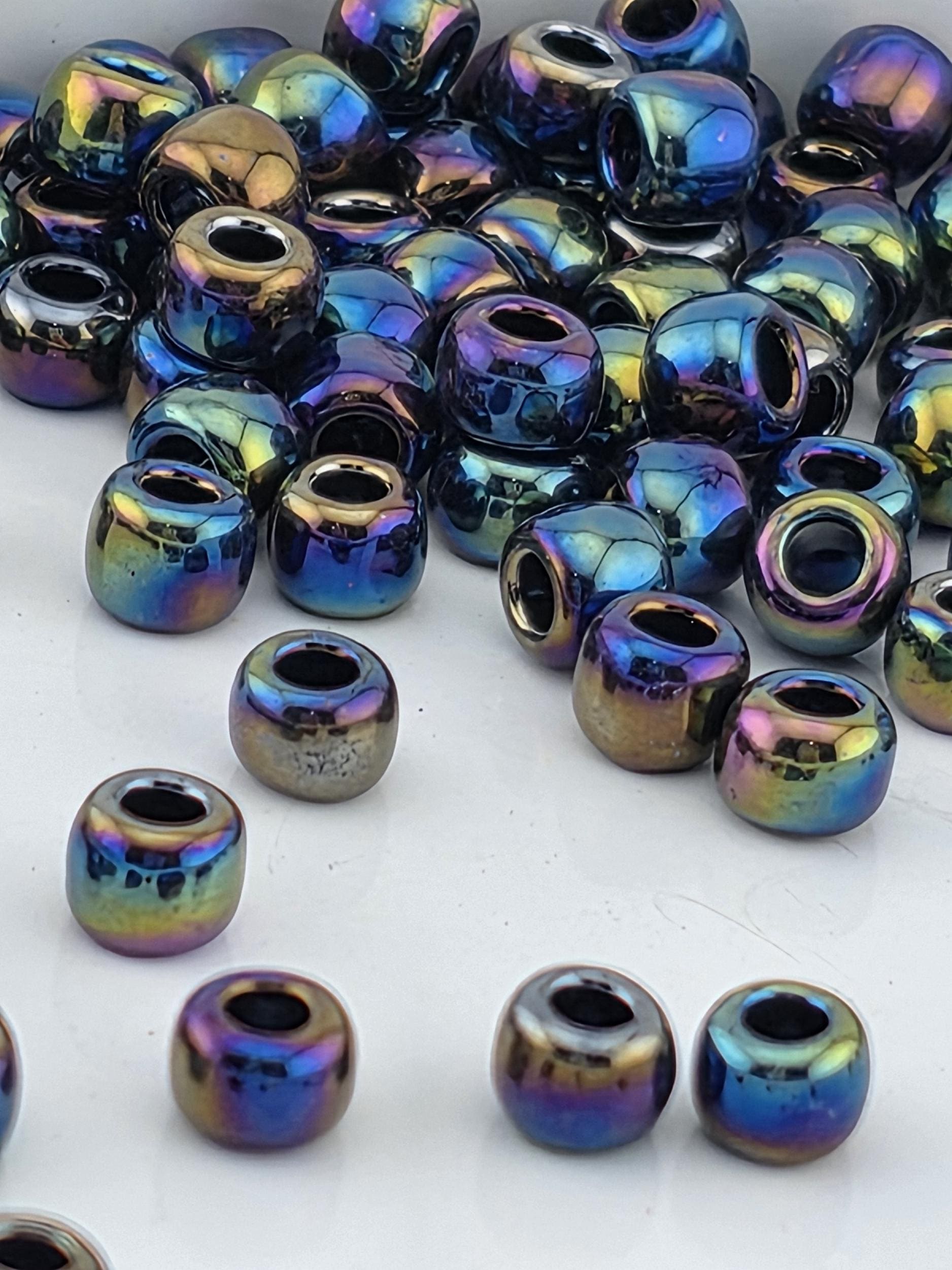 a collection of multicolored glass beads scattered on a white surface.