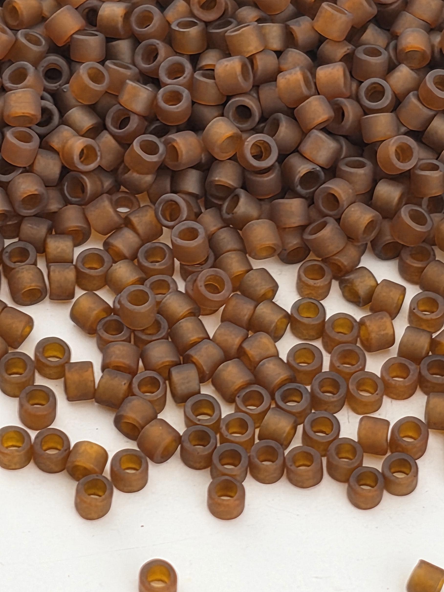 a large pile of brown, circular objects scattered on a white surface.