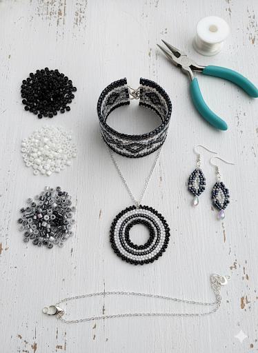 various crafting supplies, including beads, pliers, and jewelry-making tools, arranged on a white wooden surface.