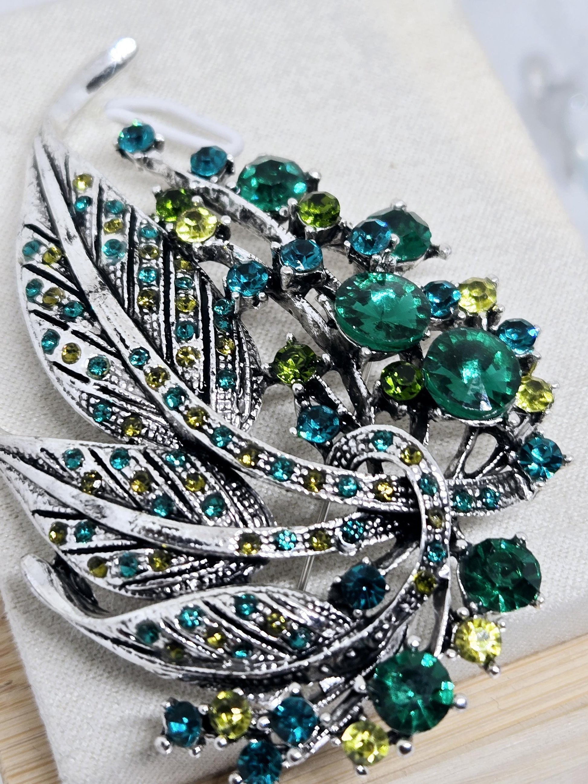 Silver Plated Feather Brooch: Blue Topaz and Emerald Rhinestone Pin