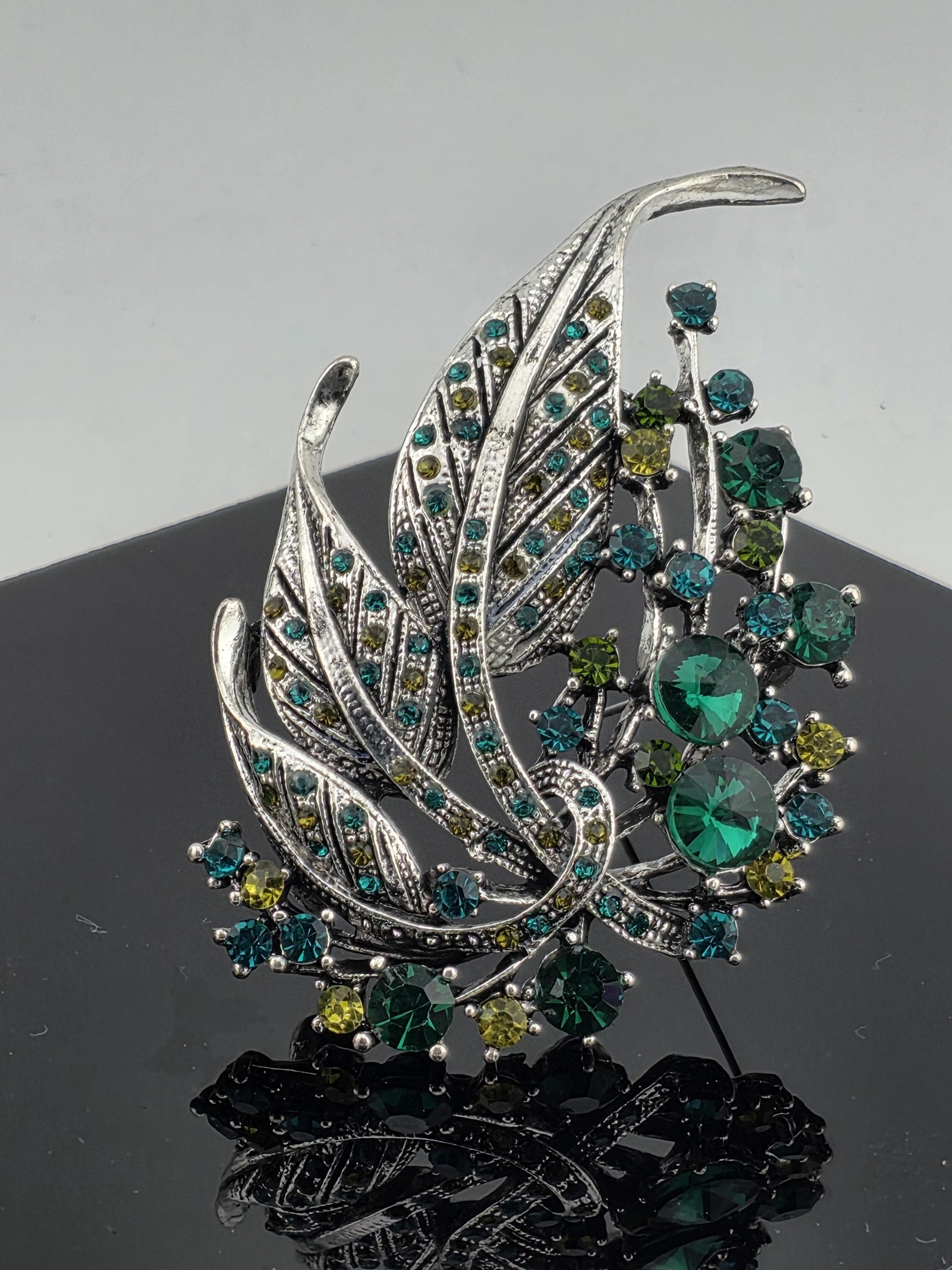 Silver Plated Feather Brooch: Blue Topaz and Emerald Rhinestone Pin