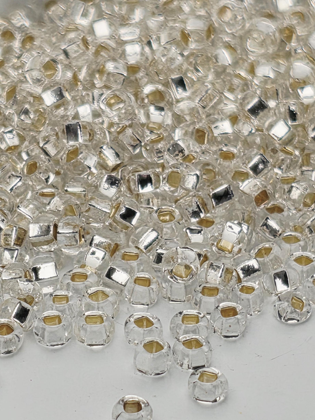 a close-up view of numerous clear glass beads scattered across a surface.