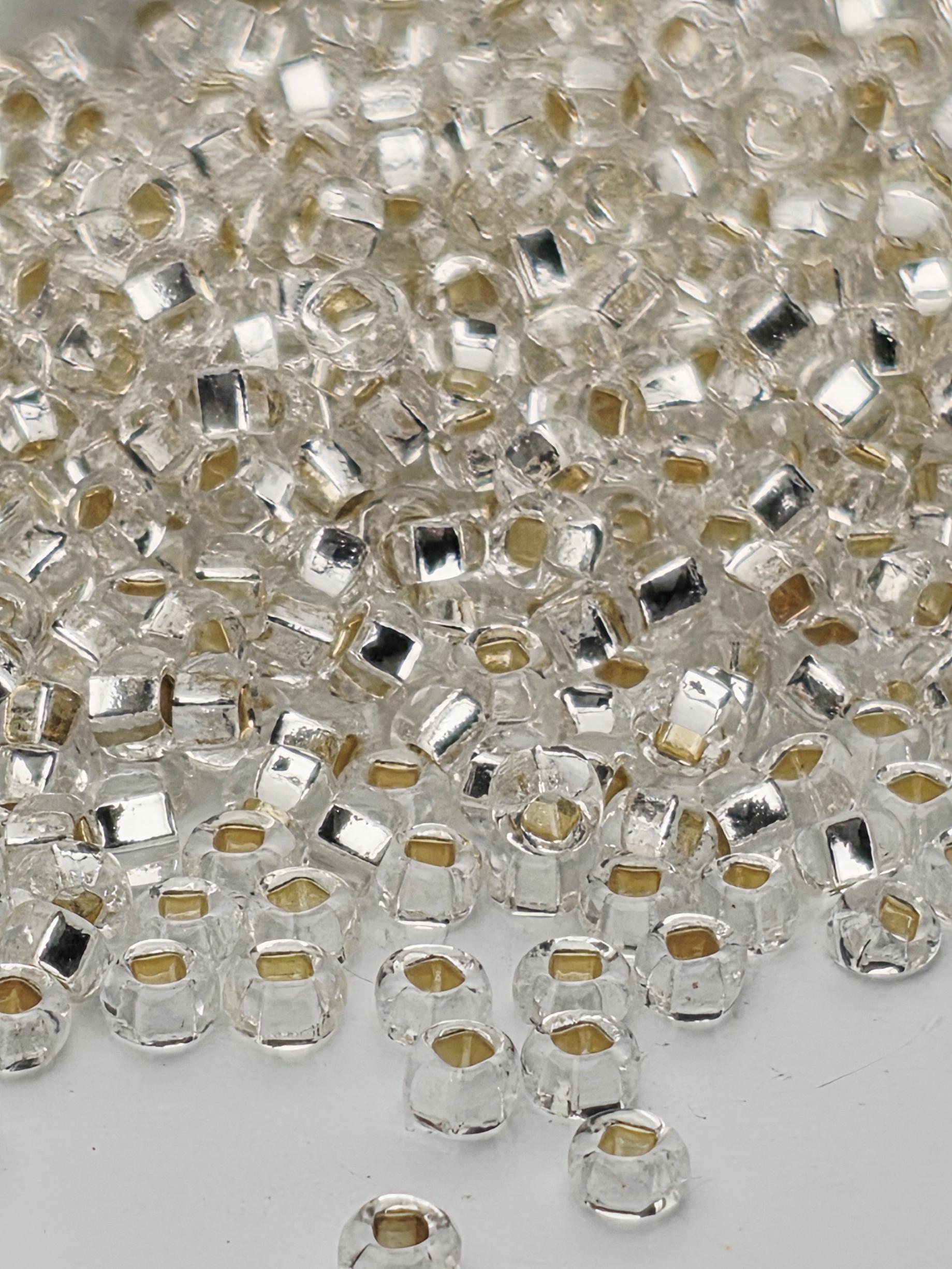 a close-up view of numerous clear glass beads scattered across a surface.